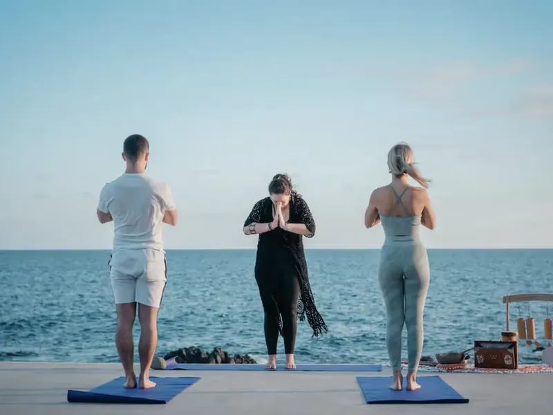 People doing yoga with ocean view