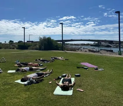 A peaceful and shaded outdoor park setting beneath the trees in Tavira, ideal for a relaxing yoga and meditation session.
