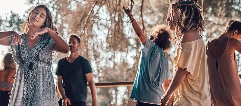 People gathering at a bright outdoor deck for an conscious ecstatic dance session in Lagos, Portugal.