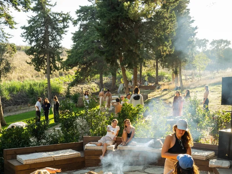People enjoying a fire pit in the forest