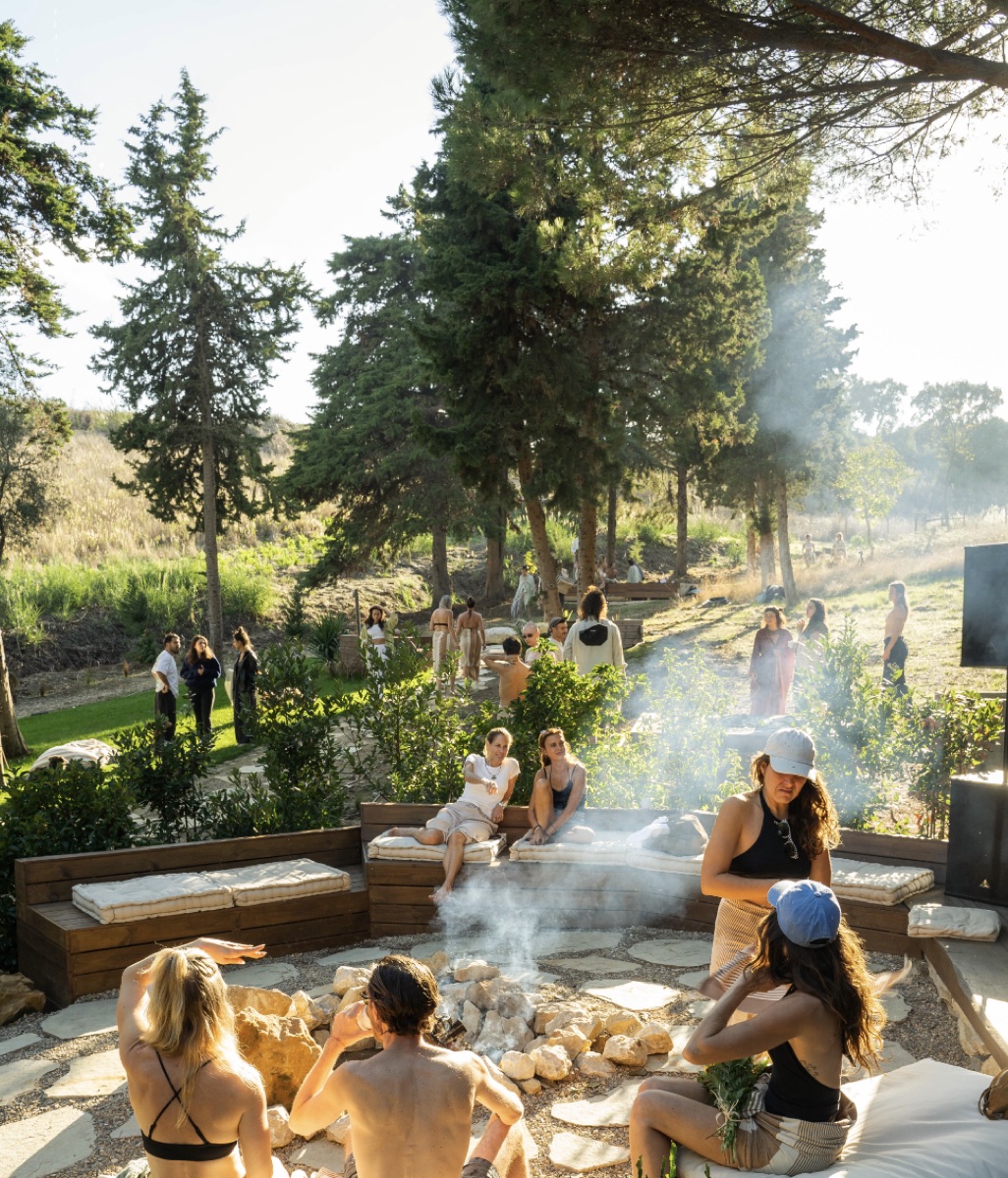 People enjoying a fire pit in the forest