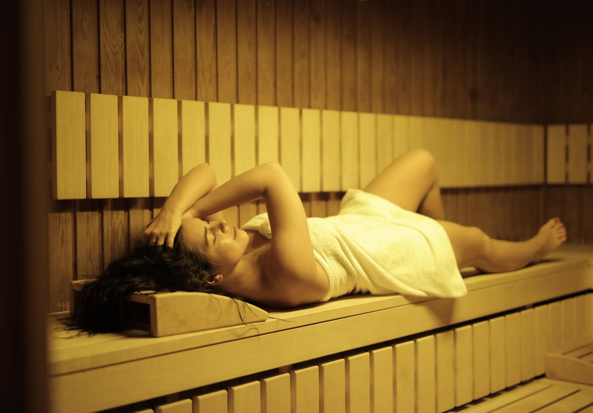 A relaxing woman in a sauna at a peaceful spa in Albufeira.