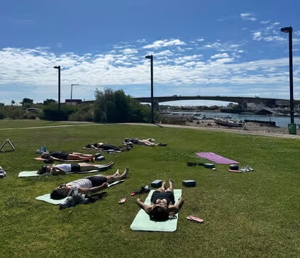 A peaceful and shaded outdoor park setting beneath the trees in Tavira, ideal for a relaxing yoga and meditation session.