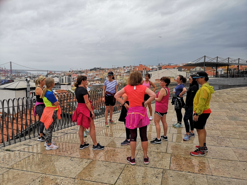 Group of runners talking on a viewpoint in Lisbon
